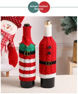 Detail of knitted Christmas wine bottle covers with bells and festive belt decorations