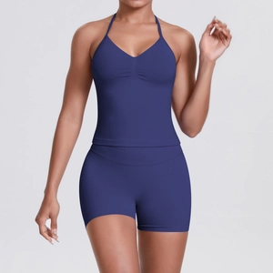 Detail of navy blue halter yoga top and high-waisted seamless shorts on a model