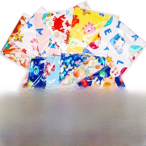 Collection of colorful cartoon pet bandanas with cat and owl prints in clear packaging