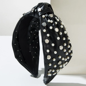 Detail of faux leather knotted headband with white pearls and silver metal studs