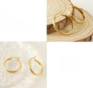 Detail showing spiral twist texture and polished 18K gold plating on steel earrings