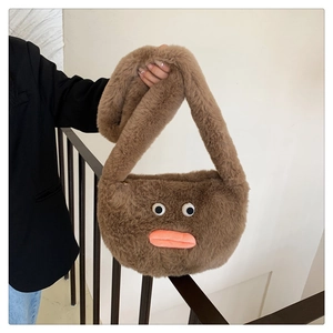 Detail of plush brown shoulder bag with quirky white eyes and funny orange sausage lips
