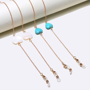 Brillenkette Set in Roségold mit Herzanhängern aus Türkis und Muschel auf weißem Sockel