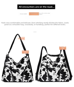 Detail view of large cow print tote bag showing versatile strap and side zipper design