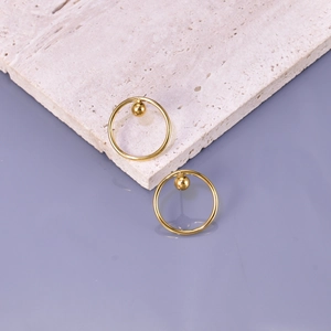 Minimalist 18k gold plated hoop earrings with dangling sphere on stone surface