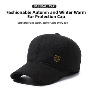 Detail of winter baseball cap with gold metal logo and fold-down ear protection