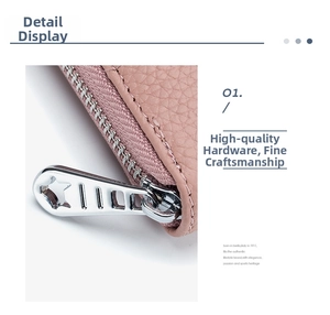 Detail of pink pebbled leather wallet featuring a silver metal star zipper pull