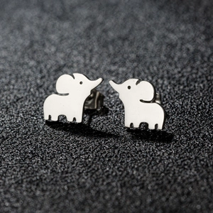 Close-up of minimalist silver elephant stud earrings on a textured black background
