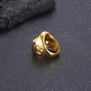 Macro detail of golden punk ring featuring intricate skull relief carving on the side band