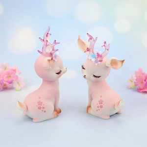 Close-up of cute pink deer figurines with dreamy bokeh background and flower petals