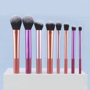 Macro detail of 8-piece professional makeup brushes with gradient fibers and aluminum handles