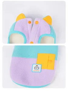 Detail of color-block fleece pet vest featuring snap buttons and a decorative badge