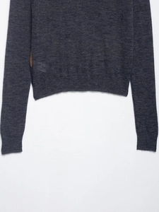 Detailed view of the ribbed hem and knit texture on a dark grey long-sleeve polo sweater