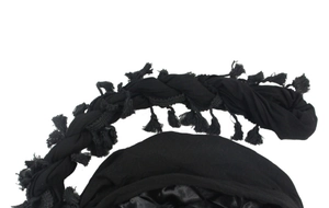 Detail of black head wrap with twisted rope braid and fringe tassels featuring satin lining