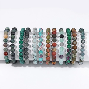 Detail of 11 natural 8mm stone bead bracelets with various textures on a white display