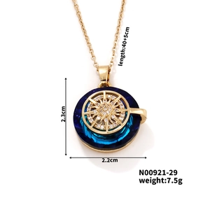 Detailed view of gold sun pendant with blue gradient crystal and size measurements