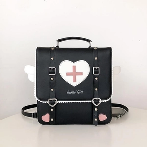 Close-up of heart and cross prints with white lace trim on black Lolita backpack
