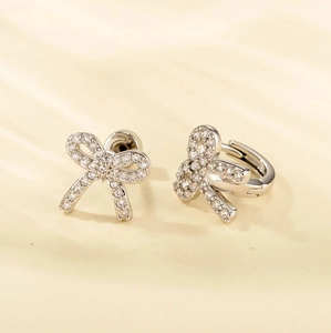 Sparkling silver bow knot earrings with pavé crystals in stud and hoop styles