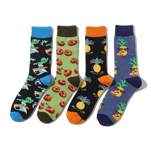 Detail of four colorful socks featuring tomato, pineapple and alien knit patterns