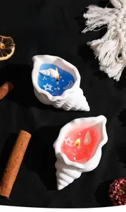 Detailed top view of conch shell scented candles with ocean-themed decorative pearls