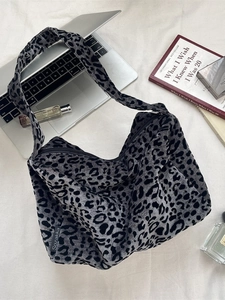 Large vintage leopard print tote bag for women with zipper closure on a white surface
