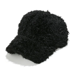 Close-up of black plush winter baseball cap showing thick faux fur material and curved brim