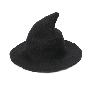 Detailed view of the black knitted witch hat showing fine fabric texture and curved peak