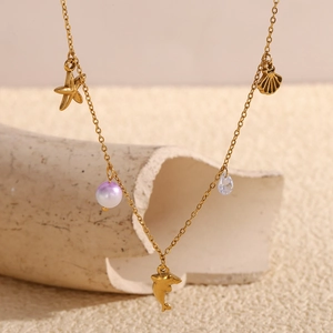 18K gold plated stainless steel necklace with starfish, shell, and dolphin ocean charms