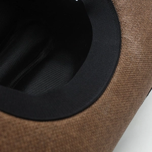 Detail shot of the brown woven straw cowboy hat with a black inner sweatband and fine stitching