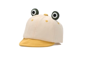 Detail of baby frog baseball cap with 3D eyes and soft yellow brim on beige crown
