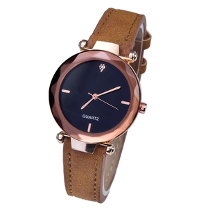 Detail of rose gold quartz watch with brown frosted strap and black diamond dial