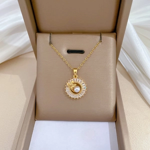 Gold leaf pendant necklace with pearl and rhinestones in a luxury jewelry box