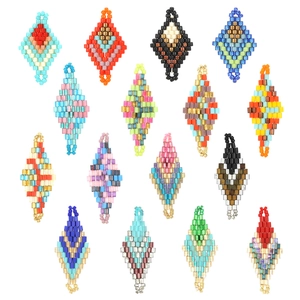 Handmade rhombus seed bead pendants in colorful mosaic patterns set on white background