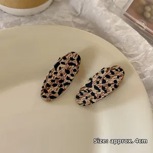Detail of two vintage leopard print oval hair clips with a length of approx. 4cm
