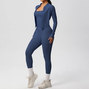 Detail of navy blue yoga set showing thumb holes on slim-fit jacket with high-waist leggings