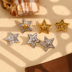Detailed view of double star earrings in gold and silver finish with natural light shadows