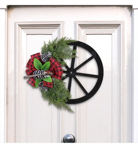 Outdoor Christmas wreath featuring a rustic black wheel, pine cones, and red plaid bow