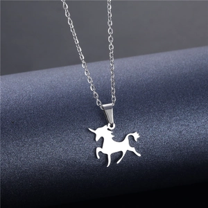 Minimalist silver unicorn pendant necklace in stainless steel shown on a blue display stand