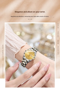 Detail of quartz watch with gold dial, crystal indices and two-tone metal strap on wrist