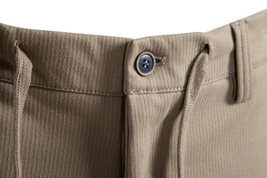 Macro view of khaki trousers showing vertical knit texture and navy blue button detail