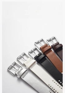 Detail view of colorful punk rivet belts with square metal buckles for women's jeans