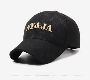 Detail of black baseball cap featuring gold NY&JA 3D embroidery and subtle letter print