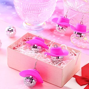 Close-up of disco ball earrings with pink cowboy hats in a decorative gift box