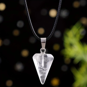 Macro detail of hexagonal white crystal pendant with silver clasp and black cord