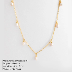 Macro detail of a 5mm pearl pendant on 14K gold-plated stainless steel chain necklace