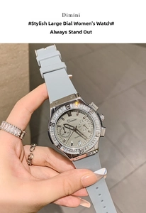 Close-up of a women's silver watch with rhinestone bezel and grey silicone strap