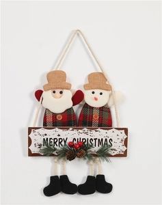 Detail of Christmas door hanger with Santa, Snowman, pine cones and Merry Christmas sign