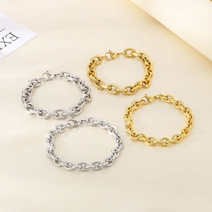 Detail view of gold and silver stainless steel chain bracelets with lobster clasps