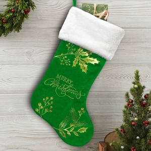 Detail of green velvet Christmas stocking with golden berry patterns and white plush cuff