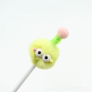 Detail of creative cartoon ballpoint pen with yellow plush monster head and spring antennae